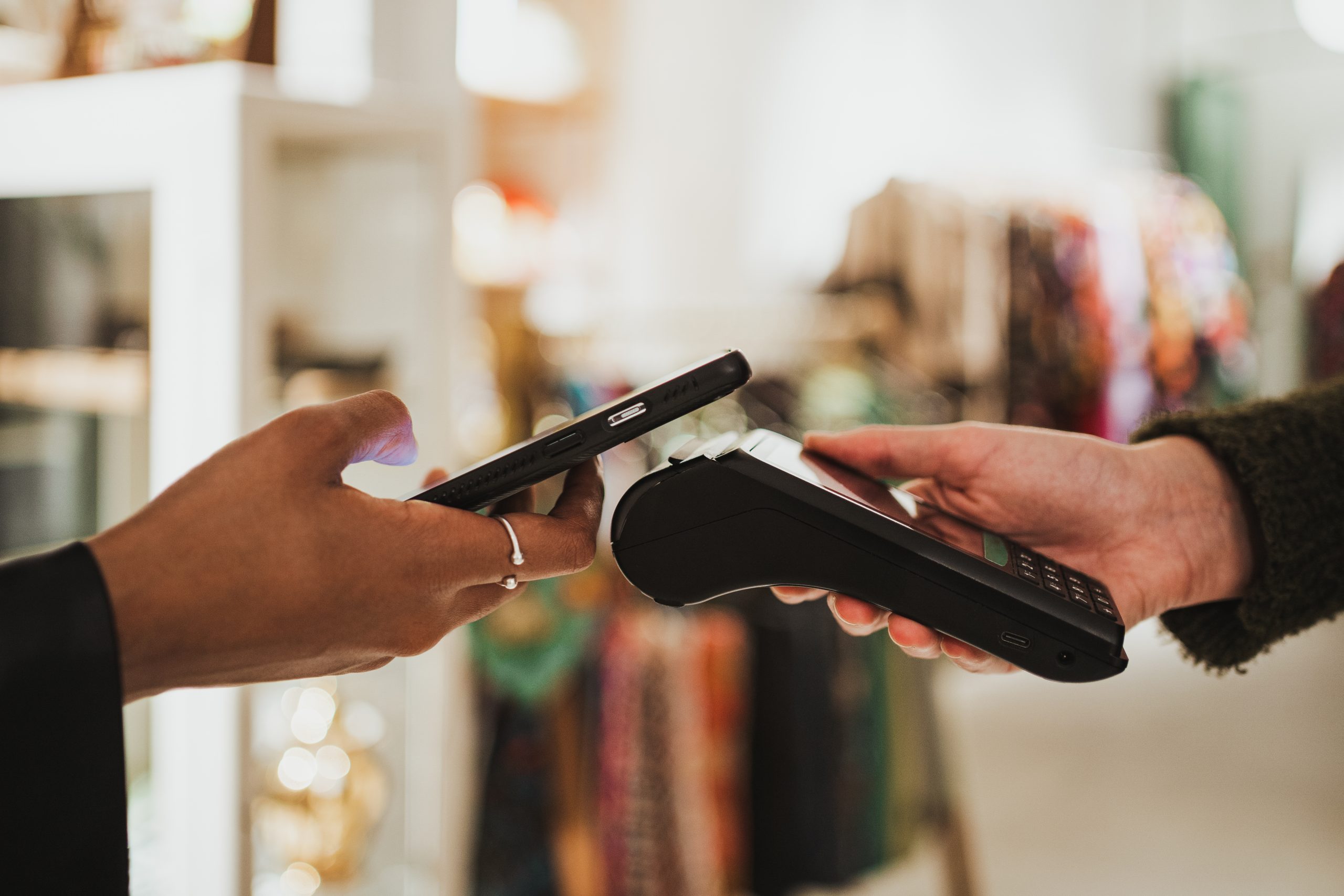 Young woman paying wireless